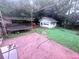 Backyard view featuring a patio, trampoline, detached garage and partially fenced yard at 2331 Georgia Lane, Snellville, GA 30078