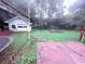 Backyard view featuring a patio, trampoline, detached garage and partially fenced yard at 2331 Georgia Lane, Snellville, GA 30078