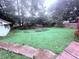 Lush backyard showcasing a fenced garden, expansive lawn, and mature trees providing ample privacy at 2331 Georgia Lane, Snellville, GA 30078