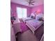 Purple bedroom with two twin beds, a white dresser, and a rainbow window covering at 2331 Georgia Lane, Snellville, GA 30078