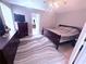 This neutral bedroom features a dark wood bedframe, ceiling fan, and gray striped rug at 2331 Georgia Lane, Snellville, GA 30078