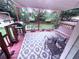 Relaxing covered deck with grill, porch swing, and decorative outdoor rug overlooking the greenery at 2331 Georgia Lane, Snellville, GA 30078