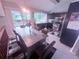 Kitchen and dining area features stainless steel appliances, dark cabinetry, and backyard view at 2331 Georgia Lane, Snellville, GA 30078