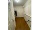 Walk-in closet featuring laminate flooring, hanging rods and shelves at 5390 Regency Lake Court, Sugar Hill, GA 30518