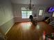Living room with hardwood floors, chandelier, and fireplace, offering a cozy space at 5390 Regency Lake Court, Sugar Hill, GA 30518