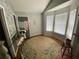 Bright living room with hardwood floors, white trim, and ample natural light at 5390 Regency Lake Court, Sugar Hill, GA 30518