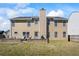 Large backyard featuring a well-maintained lawn and an inviting outdoor seating area with a stone retaining wall at 543 Walnut Way, Palmetto, GA 30268