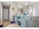 This bathroom features a double sink vanity, updated lighting, and lots of storage space at 543 Walnut Way, Palmetto, GA 30268