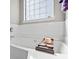 Enjoy a soak in this inviting bathtub and enjoy the natural light from the window at 543 Walnut Way, Palmetto, GA 30268