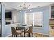 Cozy dining area with stylish lighting, a round glass table, and views of the backyard at 543 Walnut Way, Palmetto, GA 30268
