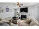 Comfortable living room with a fireplace, sectional sofa, crown molding, and hardwood floors at 543 Walnut Way, Palmetto, GA 30268