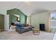 Open living area with large couch and decor, leading into an adjacent bedroom with a bed at 543 Walnut Way, Palmetto, GA 30268