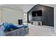 Modern living room with dark wall decor, a large couch, and a flat-screen TV at 543 Walnut Way, Palmetto, GA 30268