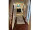 Entryway featuring hardwood floors, a staircase with a wooden banister, and a glimpse into the living room at 6438 Wedgeview Dr, Tucker, GA 30084