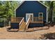 Home's exterior with a wooden deck and stairs leading to the backyard at 1321 Bridges Sw Ave, Atlanta, GA 30310