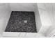 Stylish shower featuring smooth black stones on the shower floor and white marble style walls at 1321 Bridges Sw Ave, Atlanta, GA 30310