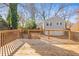 Spacious backyard featuring a wooden deck, stairs, and a two-car garage at 1450 Elizabeth Ln, Atlanta, GA 30344