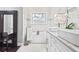Bright bathroom featuring marble walls, dual sinks, a soaking tub, and modern fixtures at 1450 Elizabeth Ln, Atlanta, GA 30344