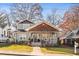 Charming two-story home with craftsman details, a welcoming front porch, and mature trees at 1450 Elizabeth Ln, Atlanta, GA 30344