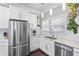 Bright kitchen featuring sleek appliances, white subway tile backsplash, and ample counter space at 1450 Elizabeth Ln, Atlanta, GA 30344