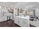 Modern kitchen with white cabinets, stainless steel appliances, and an island with a marble countertop at 1450 Elizabeth Ln, Atlanta, GA 30344
