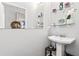 Cozy powder room featuring a pedestal sink and decorative shelving at 1450 Elizabeth Ln, Atlanta, GA 30344
