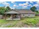 Exterior view of the home with a covered patio and landscaped backyard at 1627 Amhearst Walk Rd, Lawrenceville, GA 30043