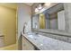 Bright bathroom features a single vanity with granite countertops and a large mirror, complemented by modern lighting fixtures at 1627 Amhearst Walk Rd, Lawrenceville, GA 30043