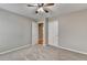 Carpeted bedroom featuring neutral paint, ceiling fan and an open door to another room at 1627 Amhearst Walk Rd, Lawrenceville, GA 30043