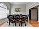 Elegant dining room with a dark wood table that seats eight, hardwood floors, and natural light at 1627 Amhearst Walk Rd, Lawrenceville, GA 30043