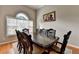 Elegant dining room with a dark wood table that seats eight, hardwood floors, and natural light at 1627 Amhearst Walk Rd, Lawrenceville, GA 30043