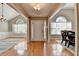Inviting foyer with hardwood floors, a front door, and views of the dining room and study at 1627 Amhearst Walk Rd, Lawrenceville, GA 30043