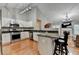 Kitchen featuring stainless steel appliances, granite counters, and hardwood floors at 1627 Amhearst Walk Rd, Lawrenceville, GA 30043