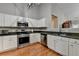 Bright kitchen featuring white cabinets, stainless steel appliances, and granite countertops at 1627 Amhearst Walk Rd, Lawrenceville, GA 30043