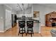 Kitchen featuring stainless steel appliances, a breakfast bar, and hardwood floors at 1627 Amhearst Walk Rd, Lawrenceville, GA 30043
