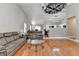 Bright, open-concept living room with hardwood floors and connections to kitchen and dining spaces at 1627 Amhearst Walk Rd, Lawrenceville, GA 30043
