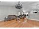 Hardwood floors accent a comfortable living room connecting to an open-plan kitchen and dining area at 1627 Amhearst Walk Rd, Lawrenceville, GA 30043