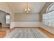 Traditional living room with wainscoting, light-filled windows, and a neutral color palette at 1627 Amhearst Walk Rd, Lawrenceville, GA 30043