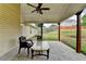 Covered patio with chairs and table overlooking backyard with privacy fence at 1627 Amhearst Walk Rd, Lawrenceville, GA 30043