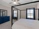 Stylish bedroom with dark frame bed, blue dresser, neutral carpet, and sheer black curtains at 1847 Davis Mill Rd, Dallas, GA 30157