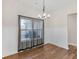 Dining room with hardwood floors, board and batten walls, and large window with backyard view at 1847 Davis Mill Rd, Dallas, GA 30157
