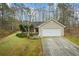 Charming single-story home with a two-car garage and a well-maintained front lawn in a wooded setting at 300 Lakeside Dr, Covington, GA 30016
