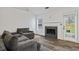 Bright living room featuring a fireplace with gray tile and patio door access to the outside at 300 Lakeside Dr, Covington, GA 30016