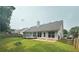 View of the home's fenced backyard with a small deck and a patio space, perfect for outdoor gatherings at 3718 Jackson Bluff Dr, Lawrenceville, GA 30044