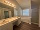 Well-lit bathroom showcasing a double vanity, soaking tub, and a separate glass-enclosed shower at 3718 Jackson Bluff Dr, Lawrenceville, GA 30044