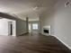 Spacious living room featuring a fireplace, ceiling fan, and dark wood flooring, creating a cozy and inviting atmosphere at 3718 Jackson Bluff Dr, Lawrenceville, GA 30044