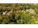 Overhead image of property including green landscapes, surrounding homes, and a river at 6305 River Chase Cir, Atlanta, GA 30328