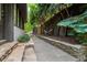 Stone pathway along home's side leading to private backyard with hammock and mature trees at 6305 River Chase Cir, Atlanta, GA 30328