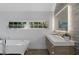Bright and modern bathroom featuring a freestanding tub, double windows and a sleek vanity at 6305 River Chase Cir, Atlanta, GA 30328
