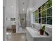 Bright bathroom boasts a double vanity, walk-in shower, and large window, offering abundant natural light at 6305 River Chase Cir, Atlanta, GA 30328